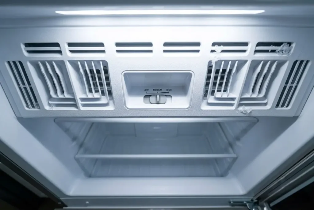 Hidden freezer slider control inside an LG top-mount refrigerator